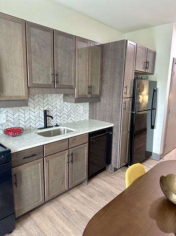 a kitchen with stainless steel appliances and wooden cabinets